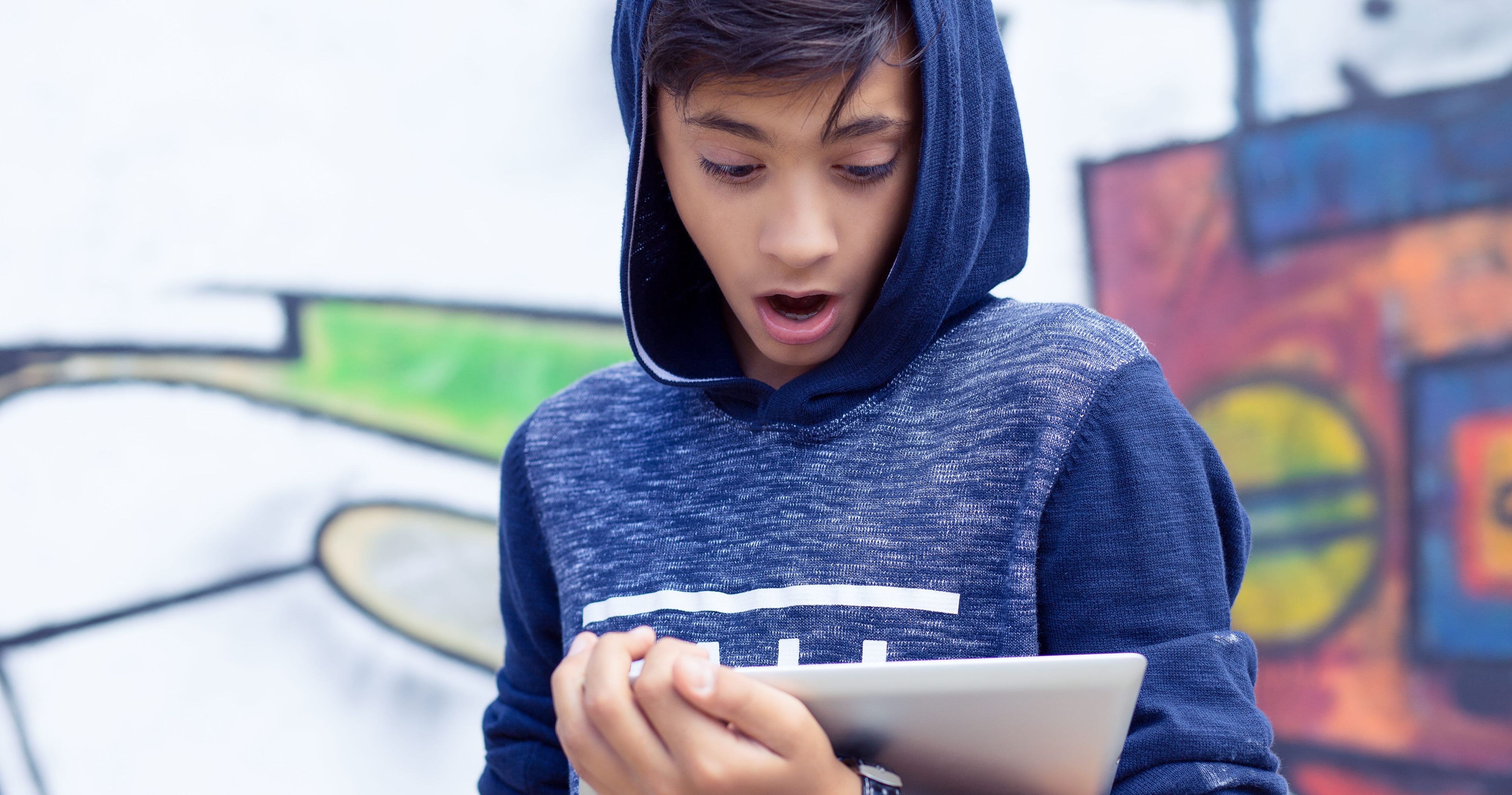 boy looking at a screen surprised