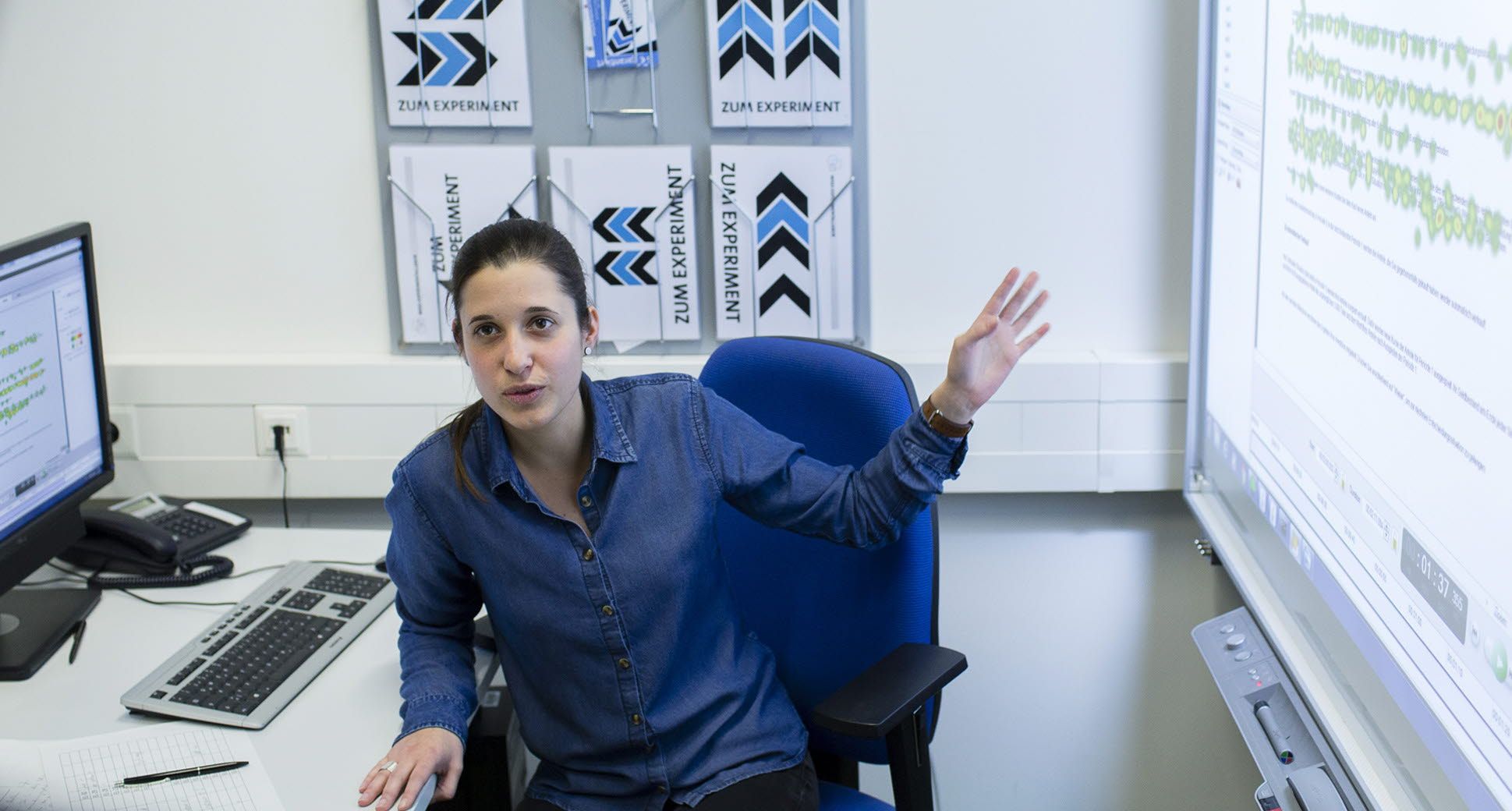 A researcher at the Hamburg University lab point out to a heatmap.