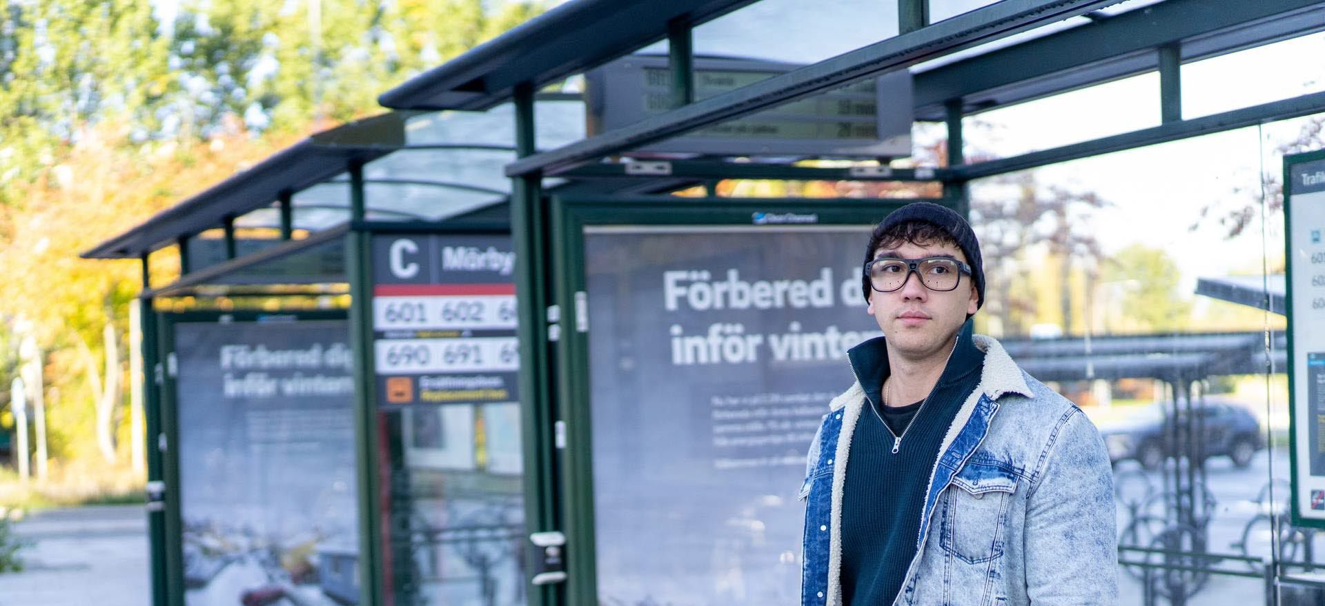 Man using Tobii Pro Glases 3 at a bus stop