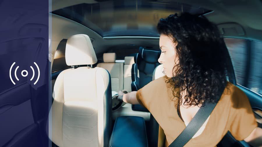 women turning around in the car while driving